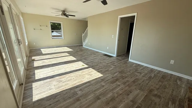 a view of balcony with wooden floor and fence and a potted plant