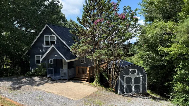 a wooden house with trees in front of it