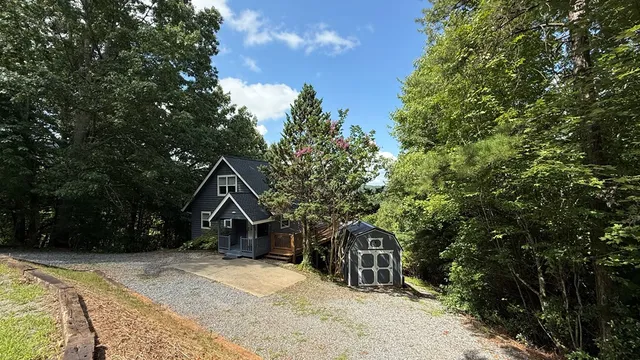a view of a wooden house with a yard