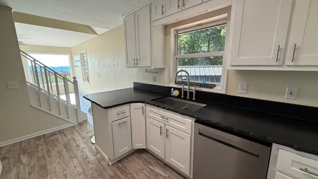 a kitchen with a stove and white cabinets
