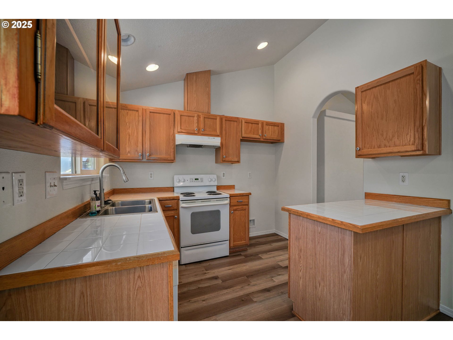 1033 E Street Independence, OR 97351 - Photo 12 of 36 a kitchen with stainless steel appliances a sink stove and cabinets