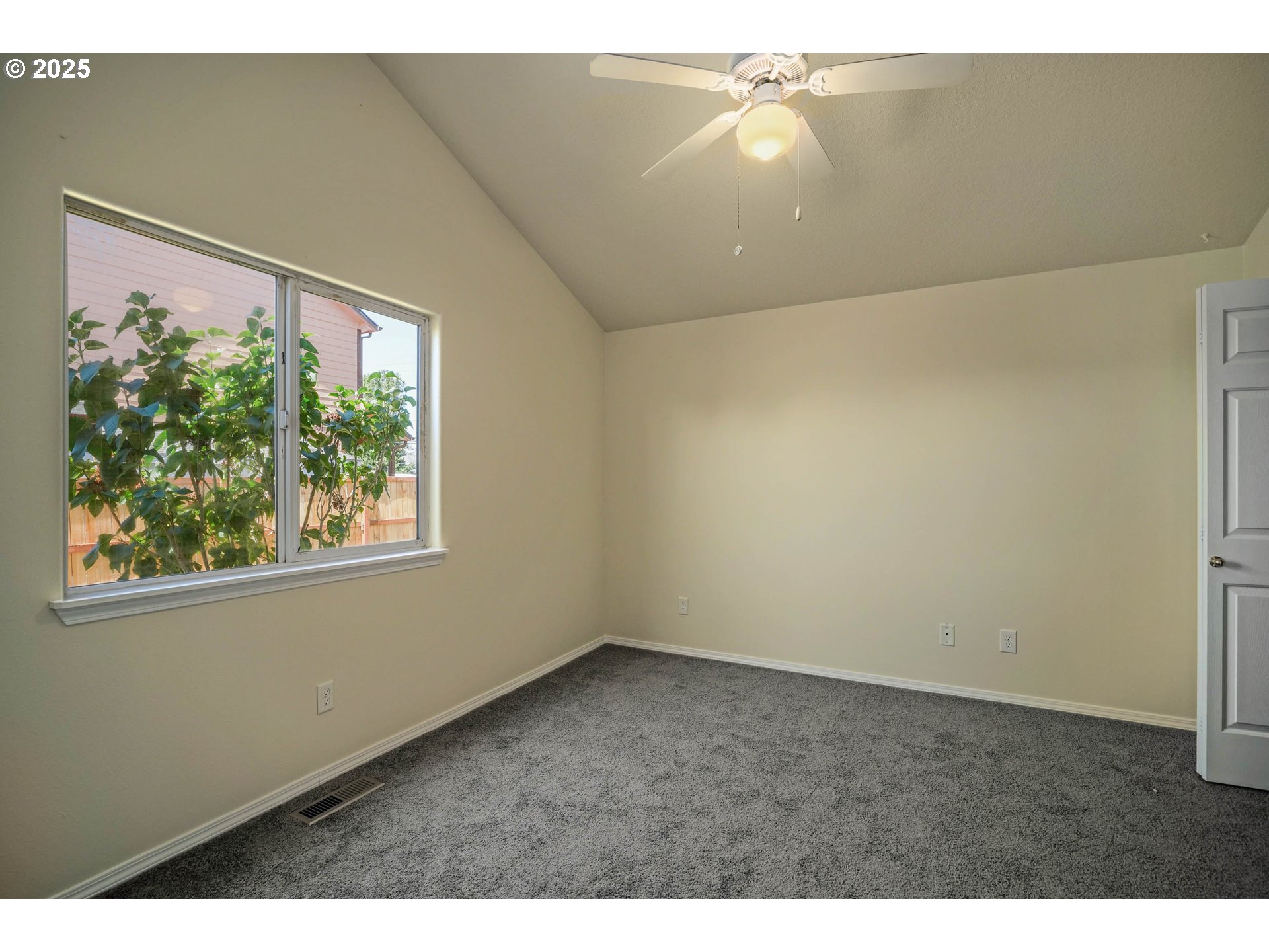 1033 E Street Independence, OR 97351 - Photo 16 of 36 a view of an empty room with wooden floor and a window