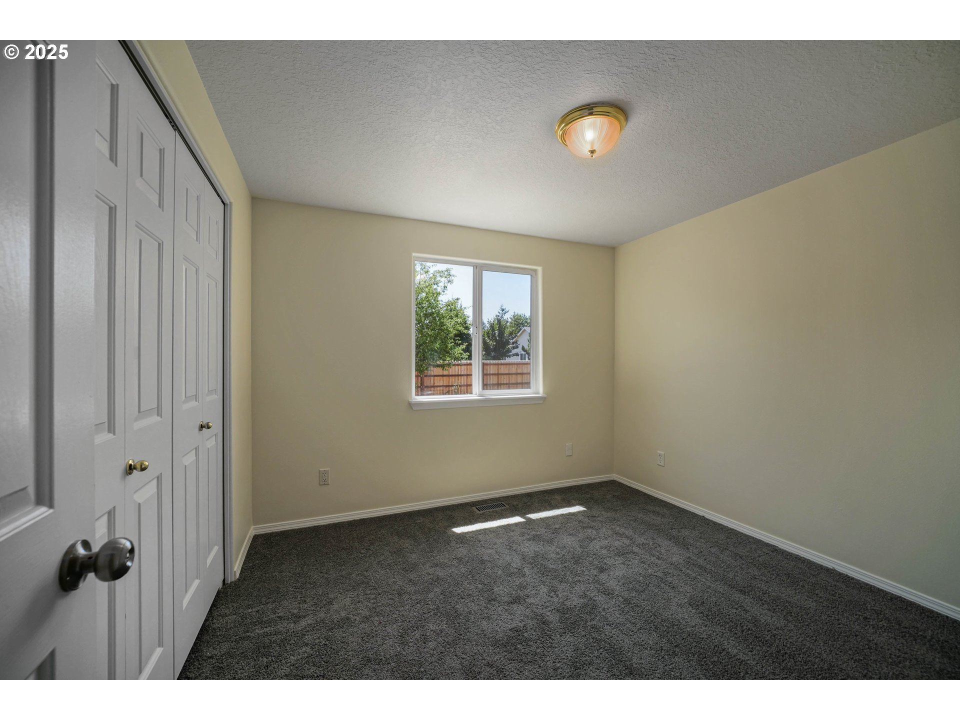 1033 E Street Independence, OR 97351 - Photo 19 of 36 a view of an empty room with a window