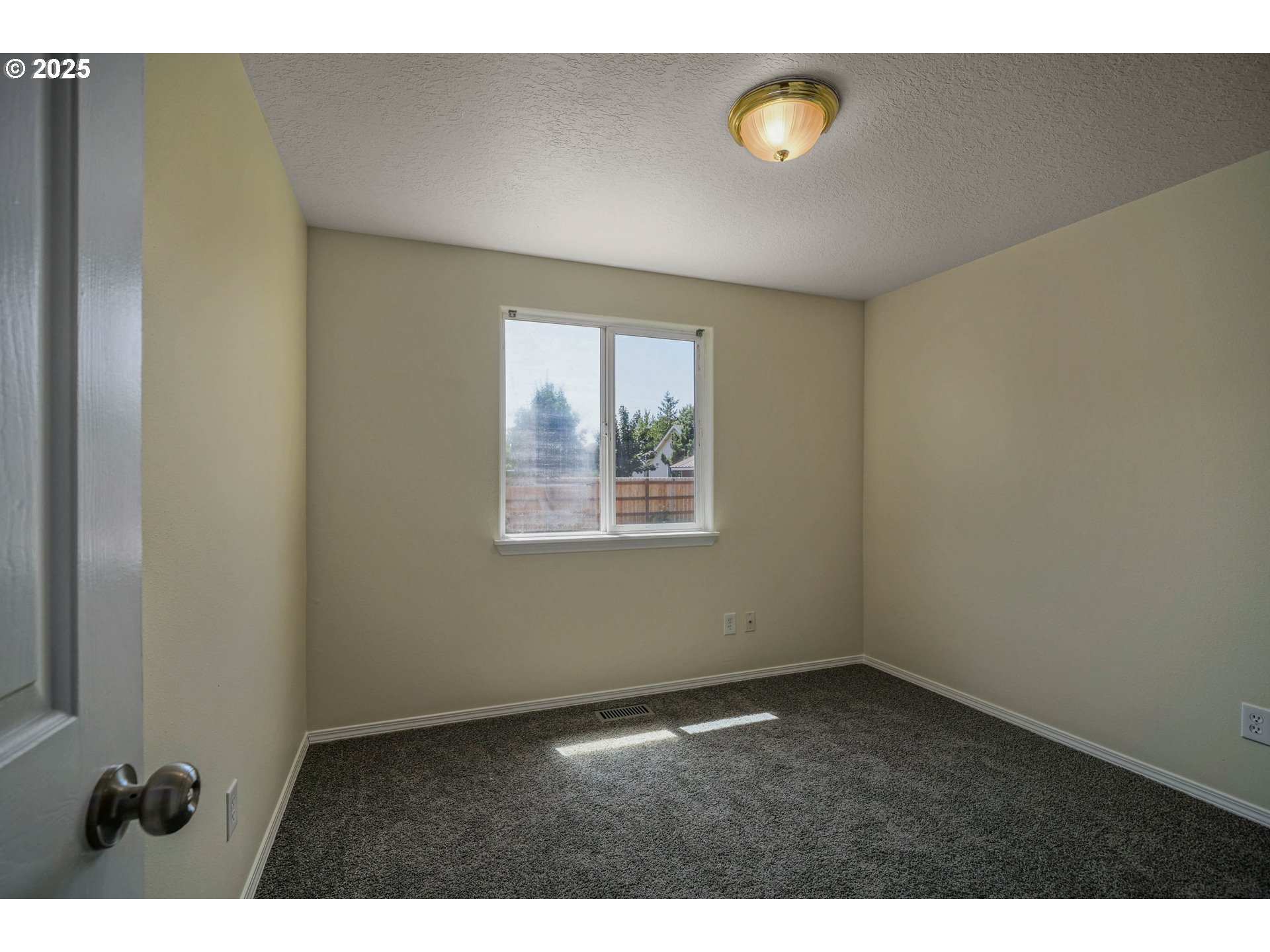 1033 E Street Independence, OR 97351 - Photo 21 of 36 a view of an empty room with a window