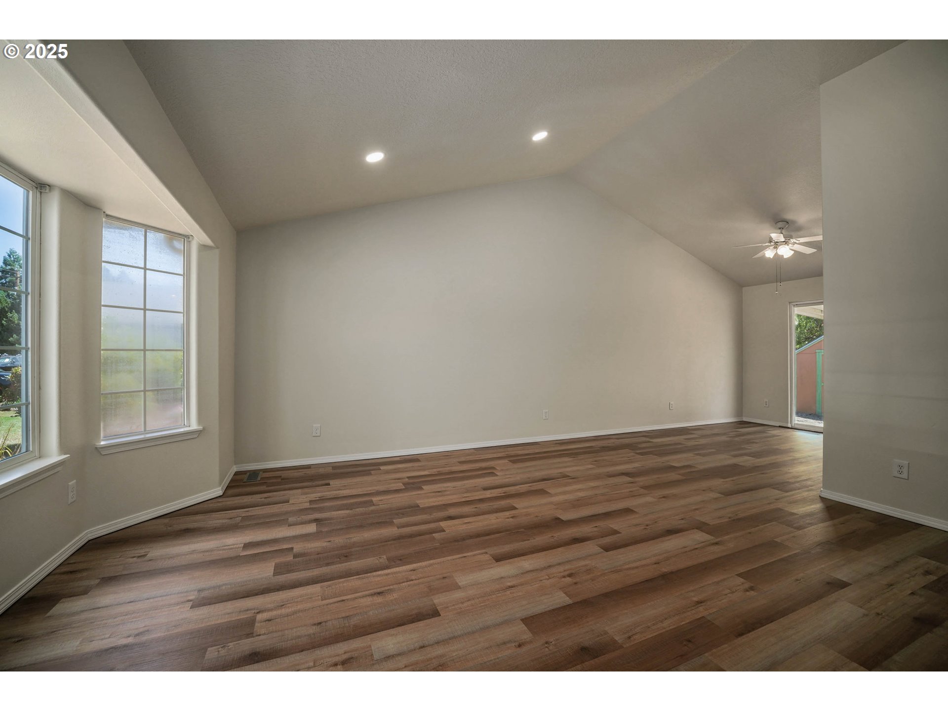 1033 E Street Independence, OR 97351 - Photo 5 of 36 a view of an empty room with wooden floor and a window