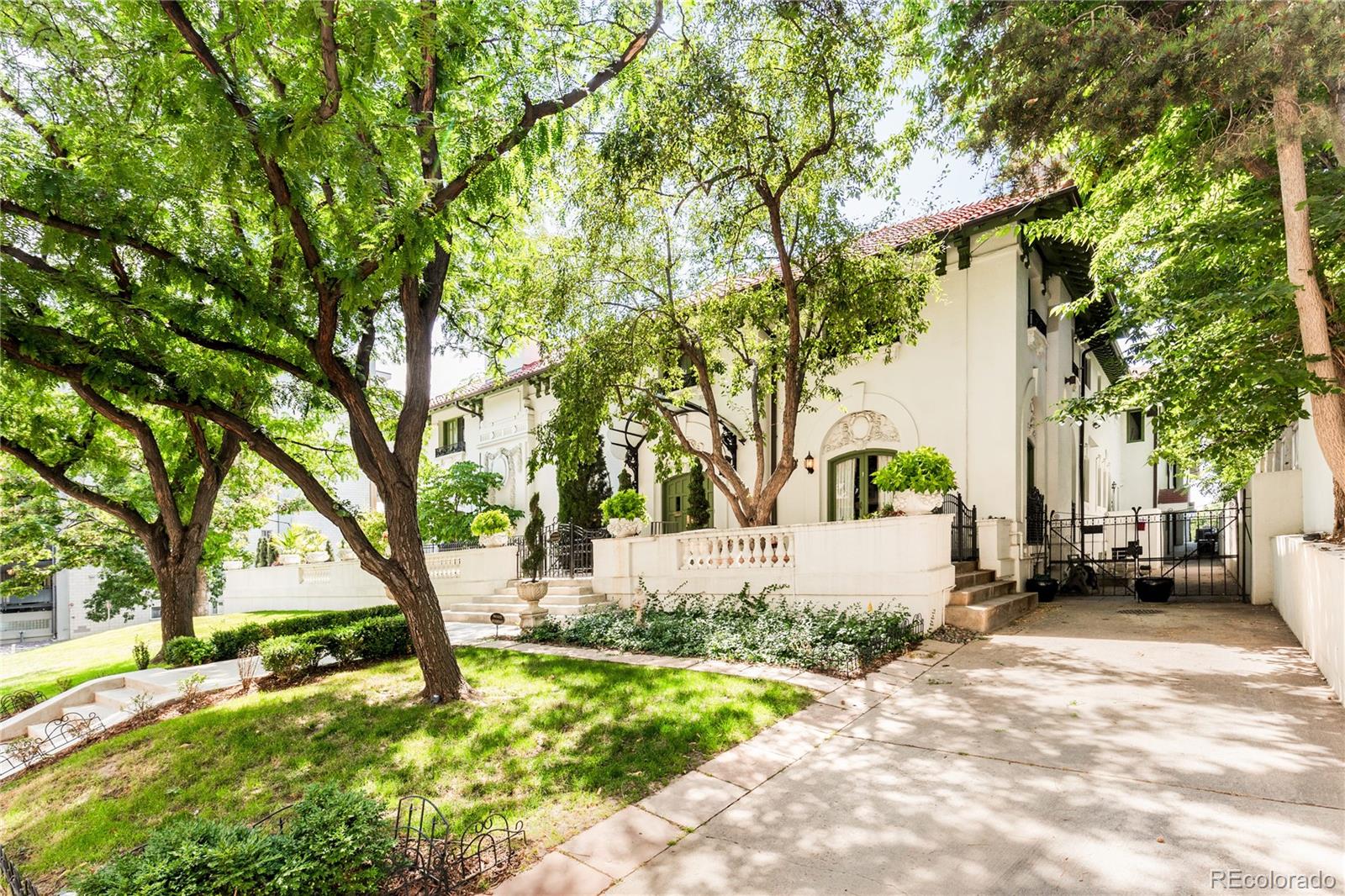 a white house that has a tree in front of it
