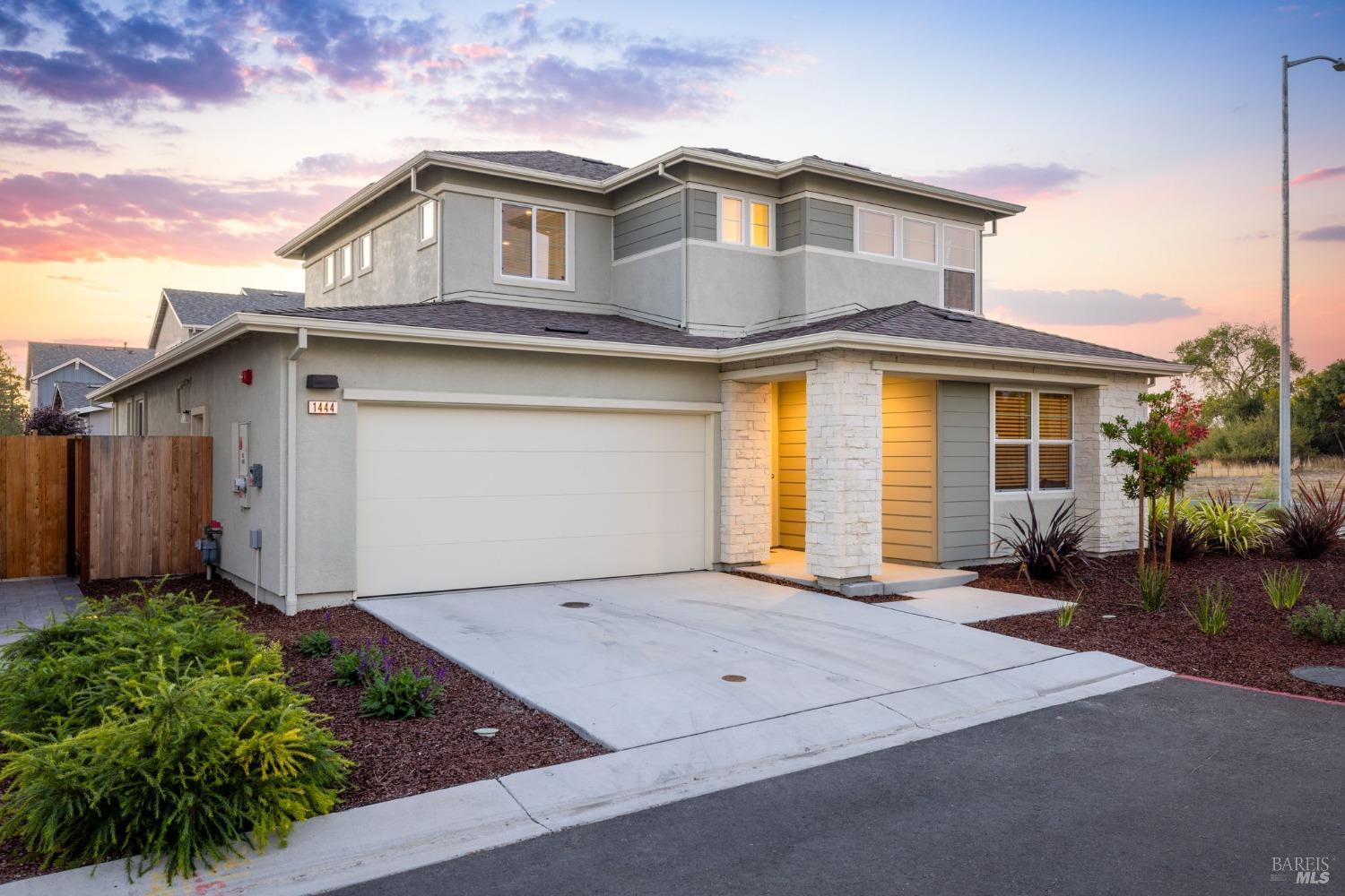 a front view of a house with a garden