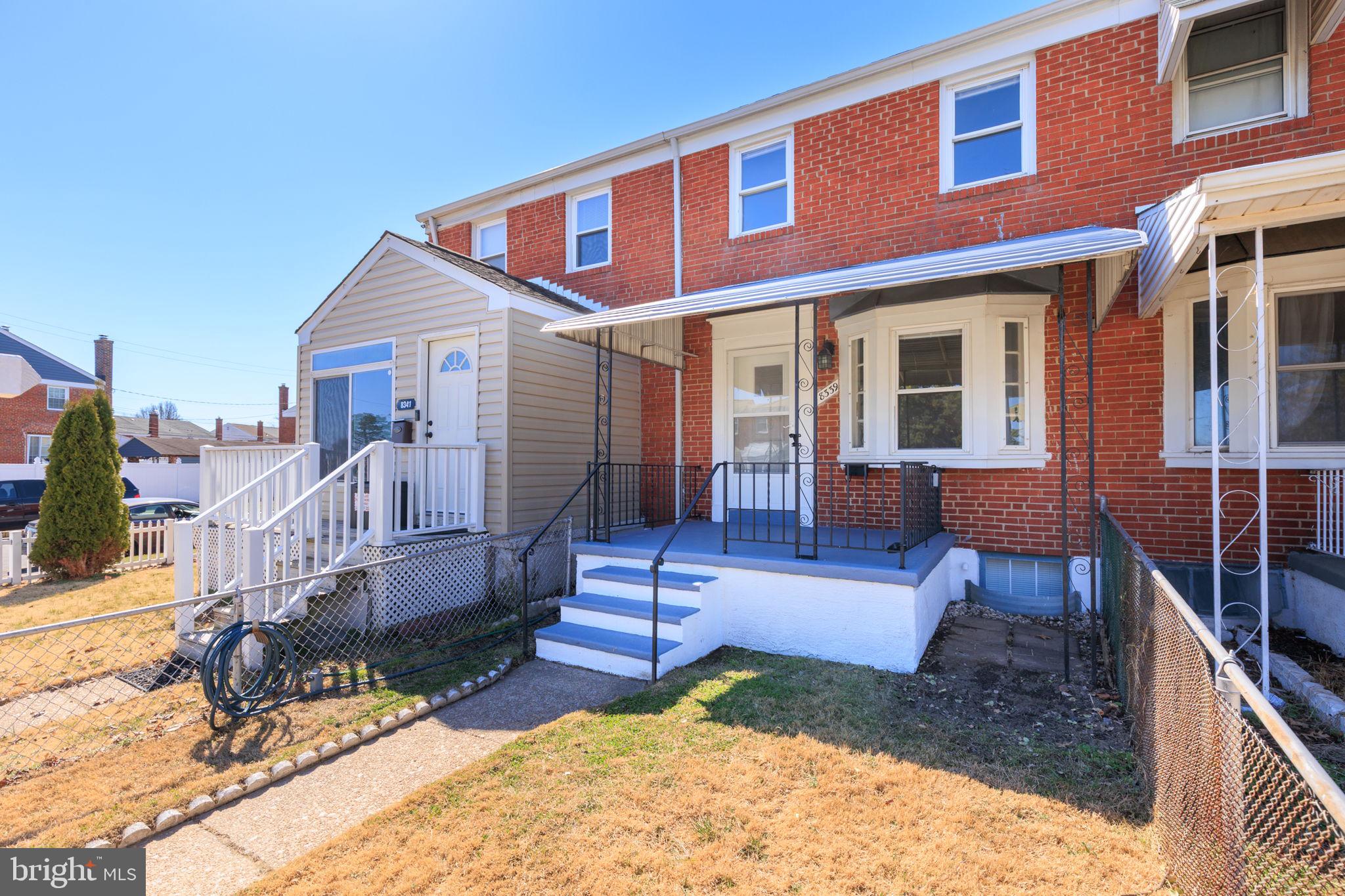 a view of a house with wooden fence