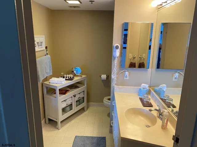 a bathroom with a sink vanity and a mirror