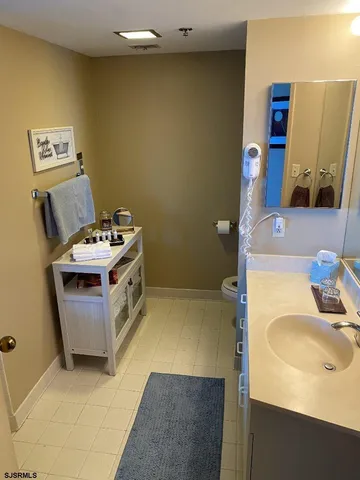 a bathroom with a sink toilet and mirror