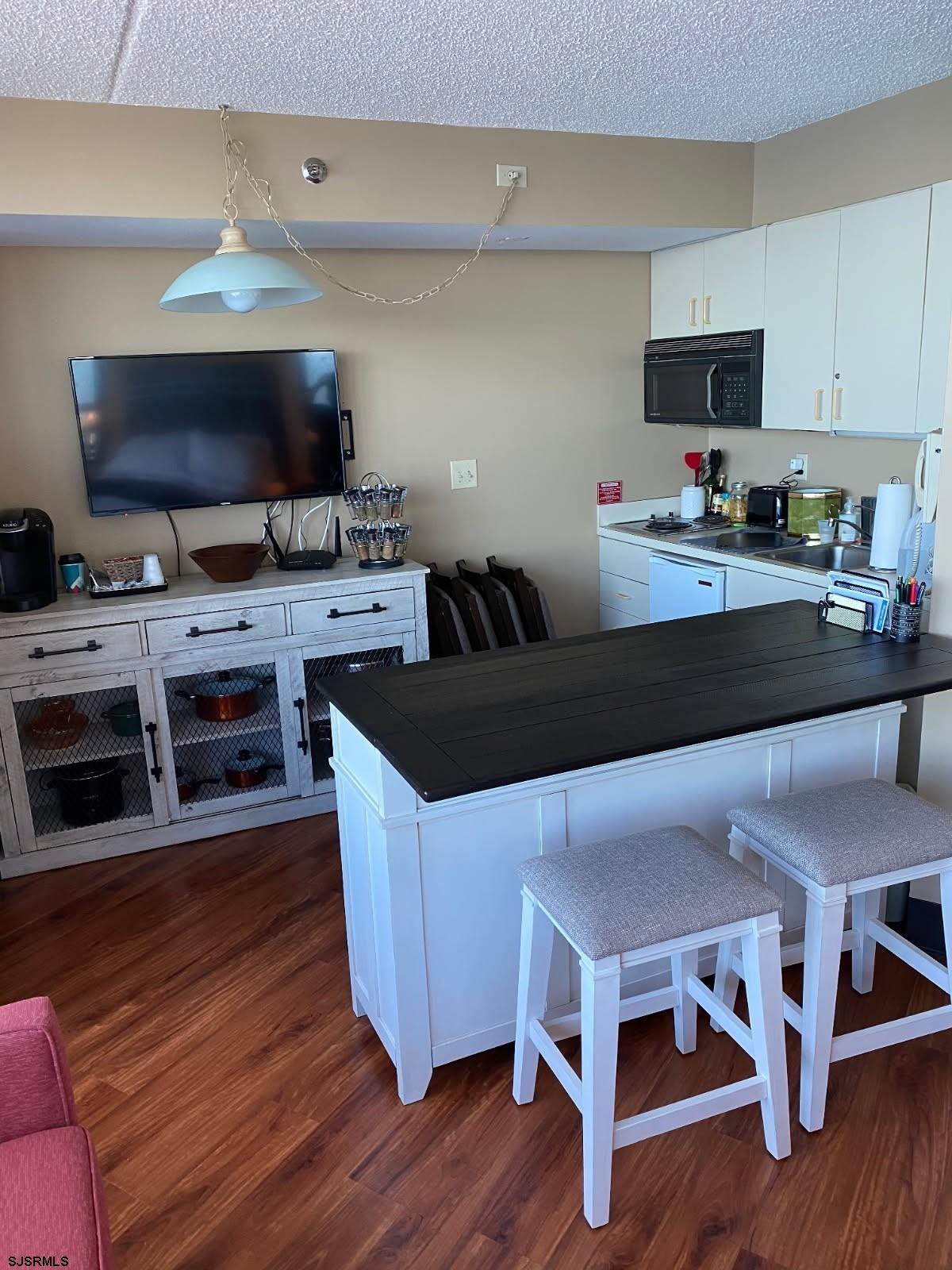 1515 Boardwalk, Unit 2805 Atlantic City, NJ 08401 - Photo 2 of 16 a kitchen with a wooden floor and a view of living room