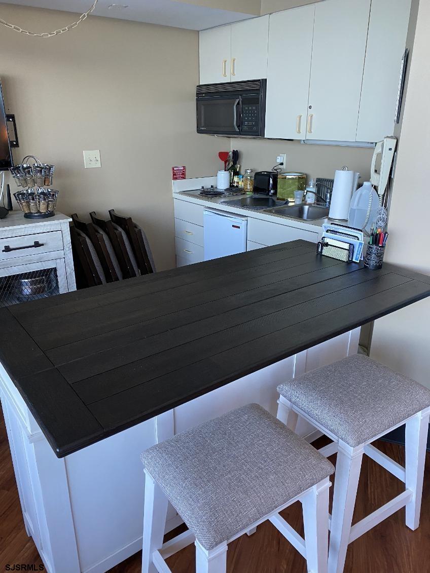 1515 Boardwalk, Unit 2805 Atlantic City, NJ 08401 - Photo 3 of 16 a kitchen with stainless steel appliances a stove a sink dishwasher and cabinets