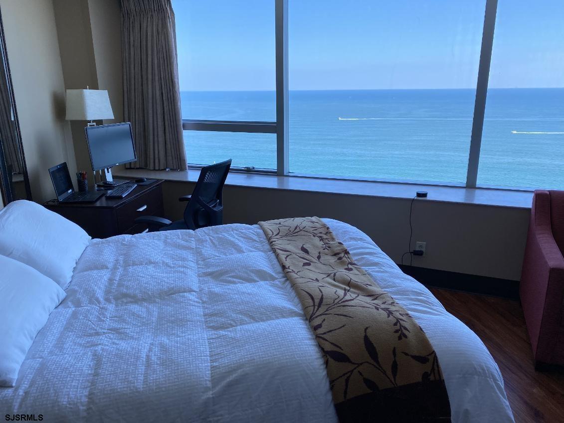 1515 Boardwalk, Unit 2805 Atlantic City, NJ 08401 - Photo 4 of 16 a bed sitting in a bedroom next to a window