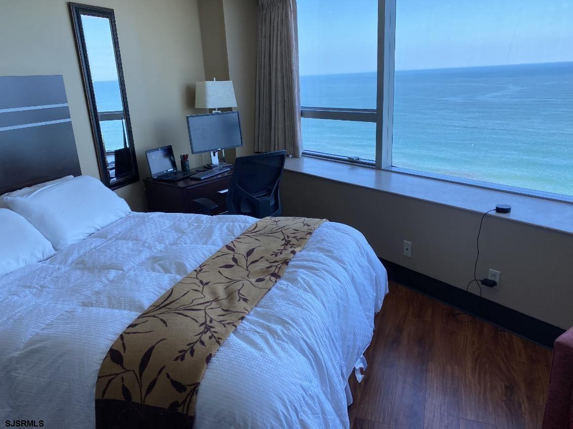1515 Boardwalk, Unit 2805 Atlantic City, NJ 08401 - Photo 5 of 16 a bed sitting in a bedroom next to a window