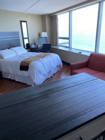 a bedroom with a large bed and large window