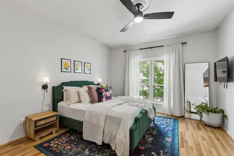 a bedroom with bed and wooden floor