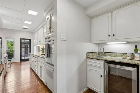 a kitchen with cabinets and wooden floor