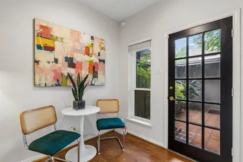 a dining room with furniture and wooden floor