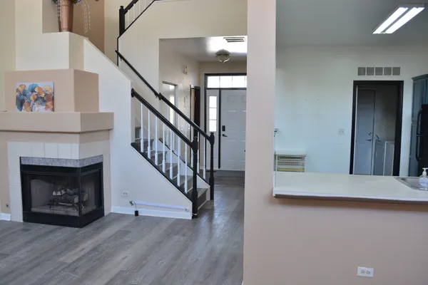 a view of a livingroom with stairs and a fireplace