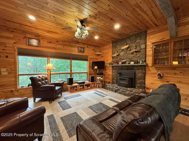 a kitchen with stainless steel appliances granite countertop a stove a refrigerator a kitchen island a sink dishwasher a dining table and chairs with wooden floor