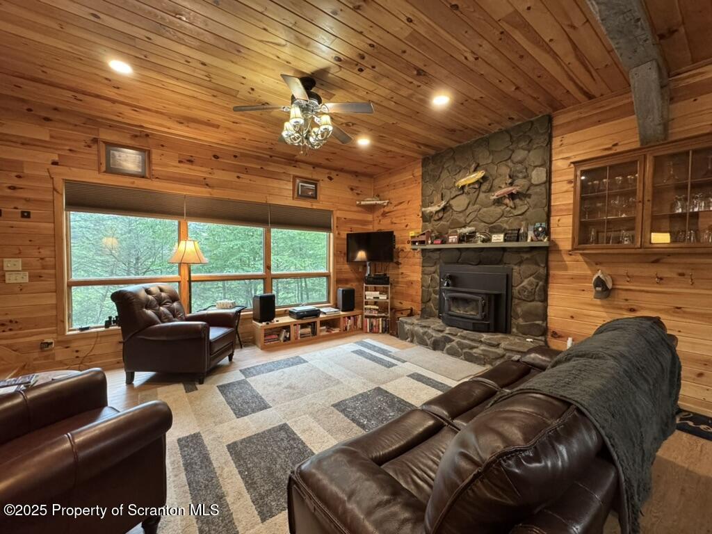 498 Penn-York Road Starlight, PA 18461 - Photo 11 of 48 a living room with furniture a fireplace and a large window