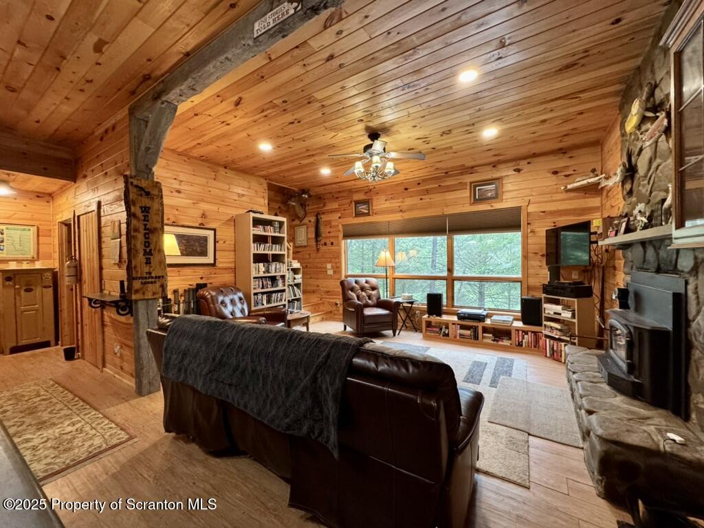 498 Penn-York Road Starlight, PA 18461 - Photo 18 of 48 a living room with furniture a large window and a fireplace