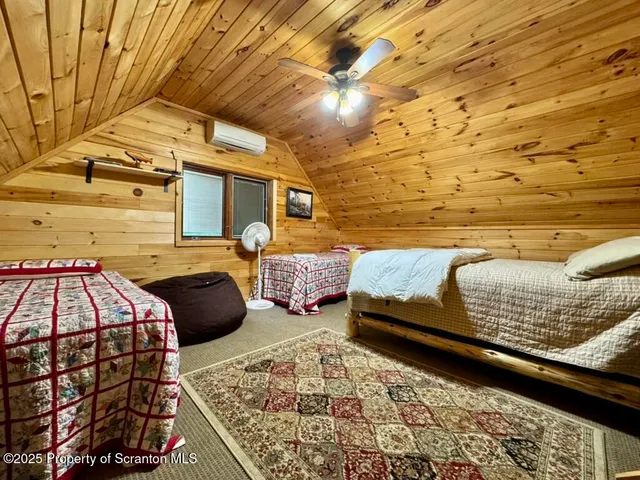 a view of a bedroom with wooden floor