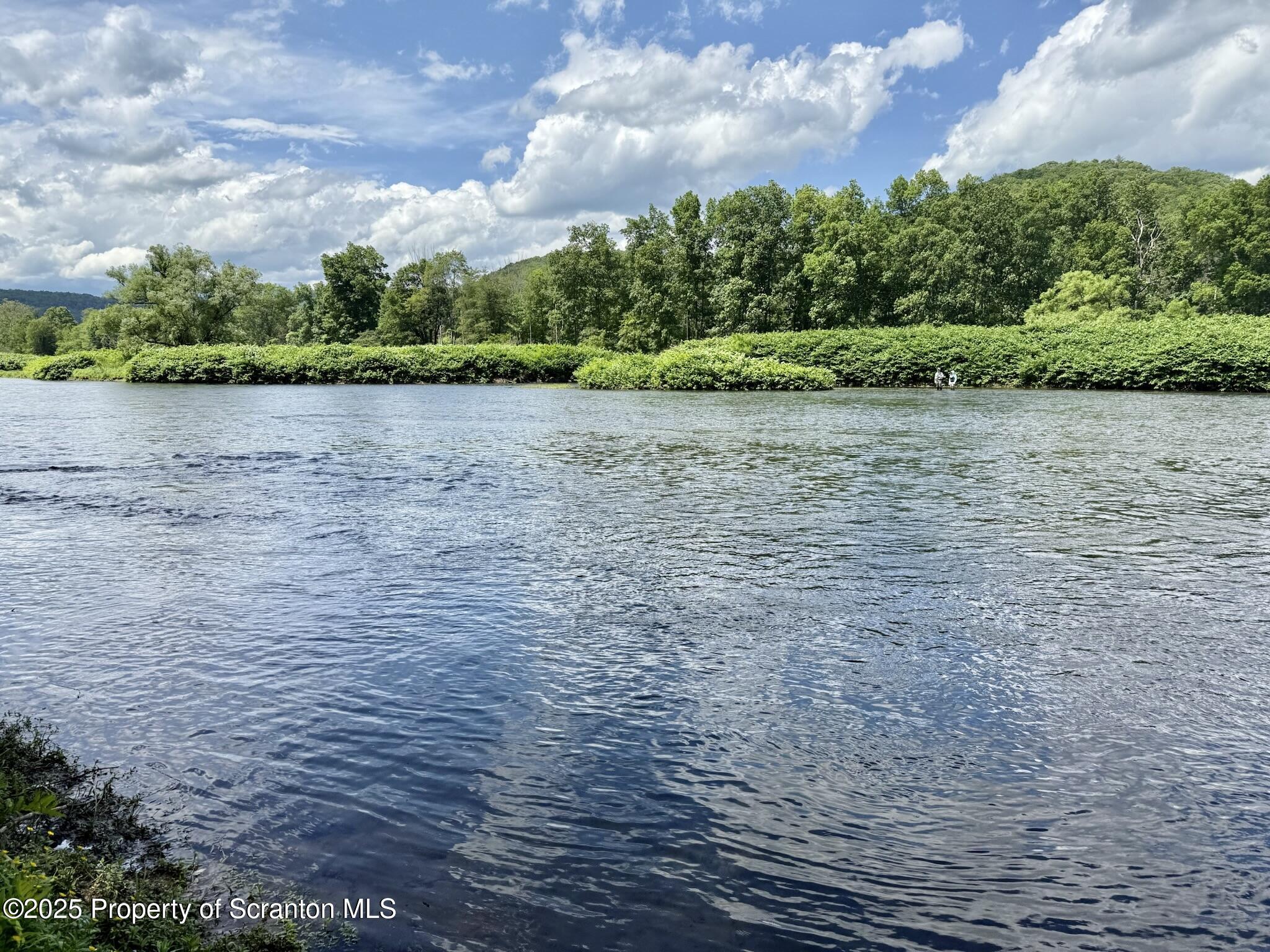 498 Penn-York Road Starlight, PA 18461 - Photo 3 of 48 a view of a lake from a yard