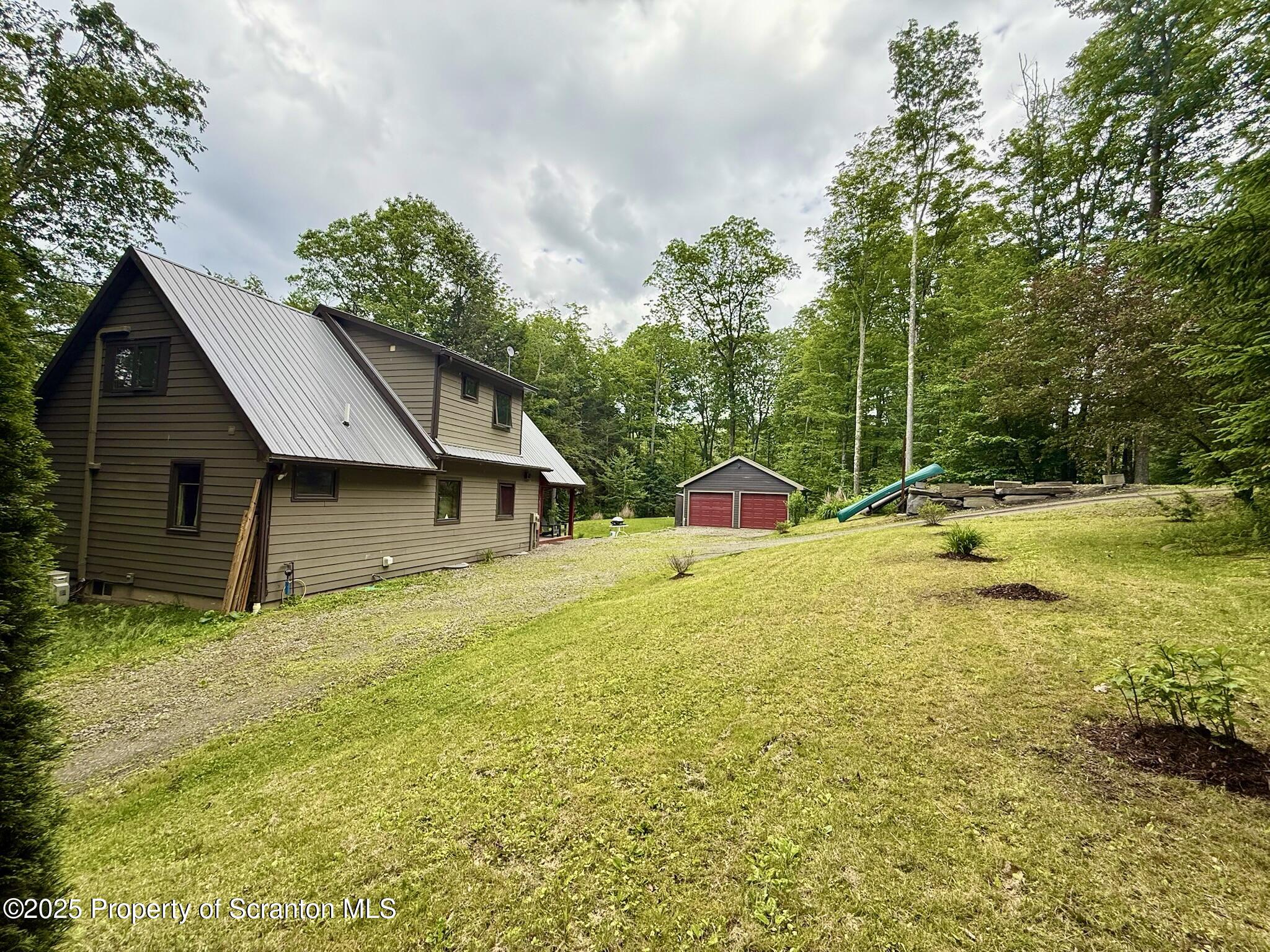 498 Penn-York Road Starlight, PA 18461 - Photo 40 of 48 a view of a house with pool and a yard