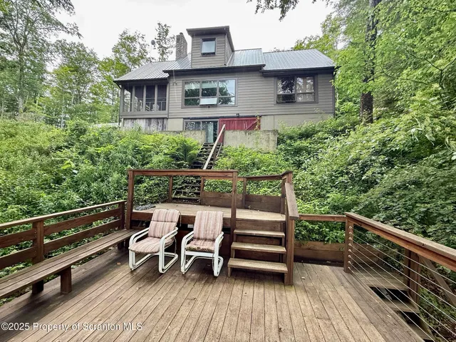 a front view of a house with a yard fire pit table and chairs