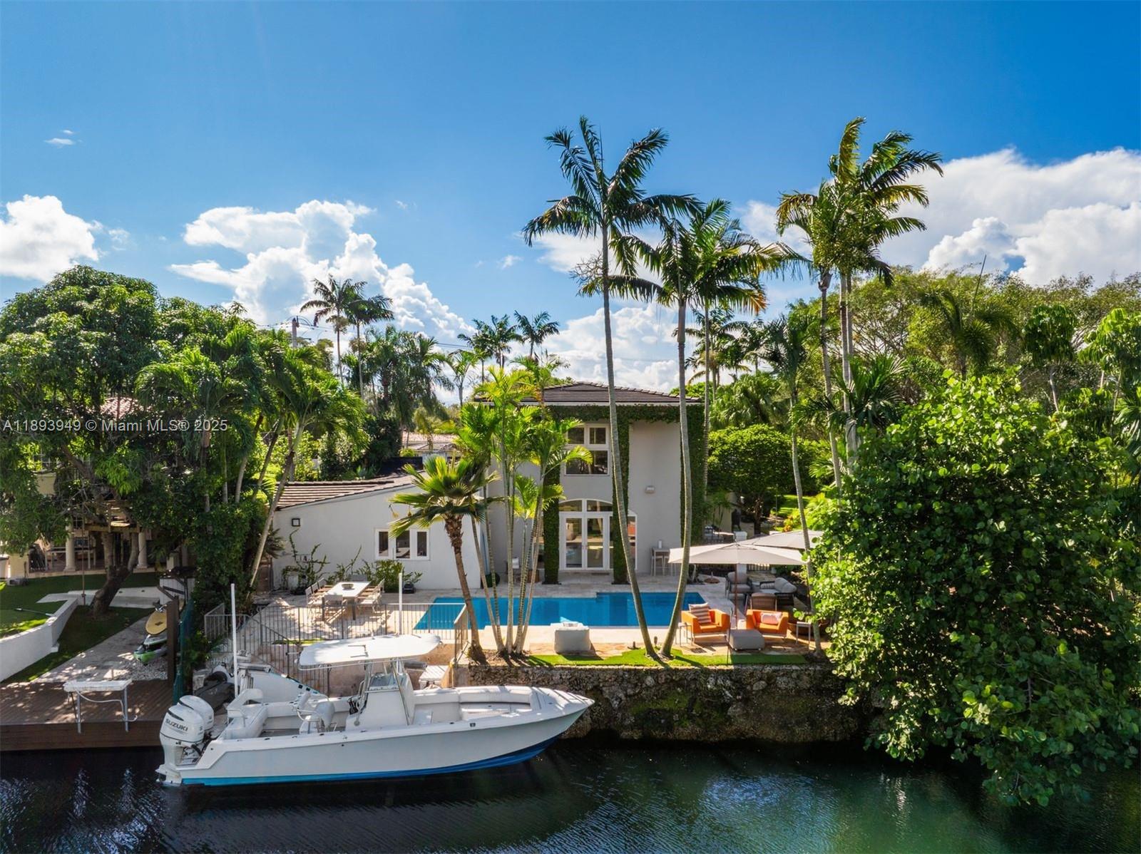 a view of a house with swimming pool and a sitting area