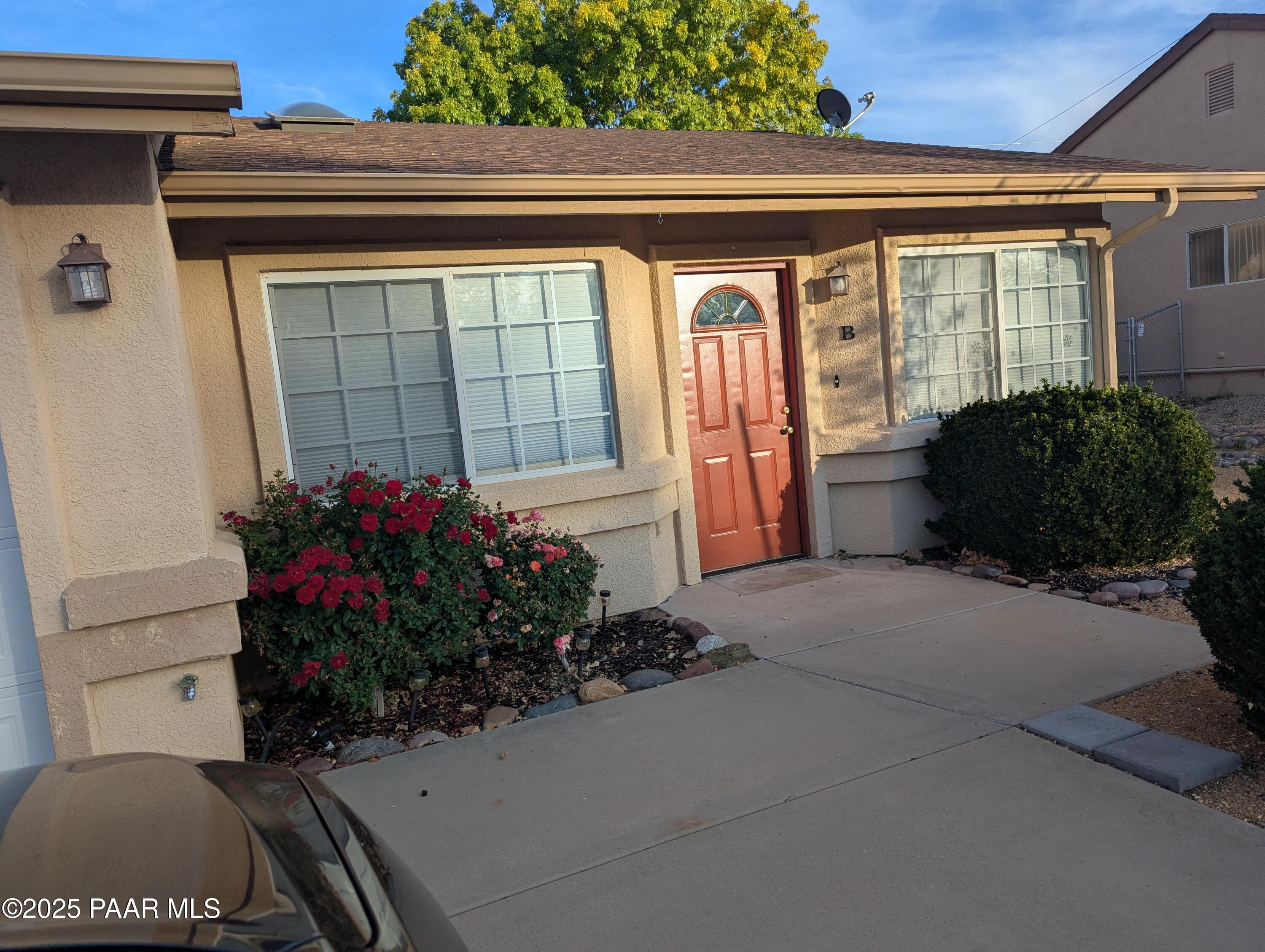 3325 East Yavapai Road, Unit B Prescott Valley, AZ 86314 - Photo 1 of 12 a potted plant sitting in front of a door