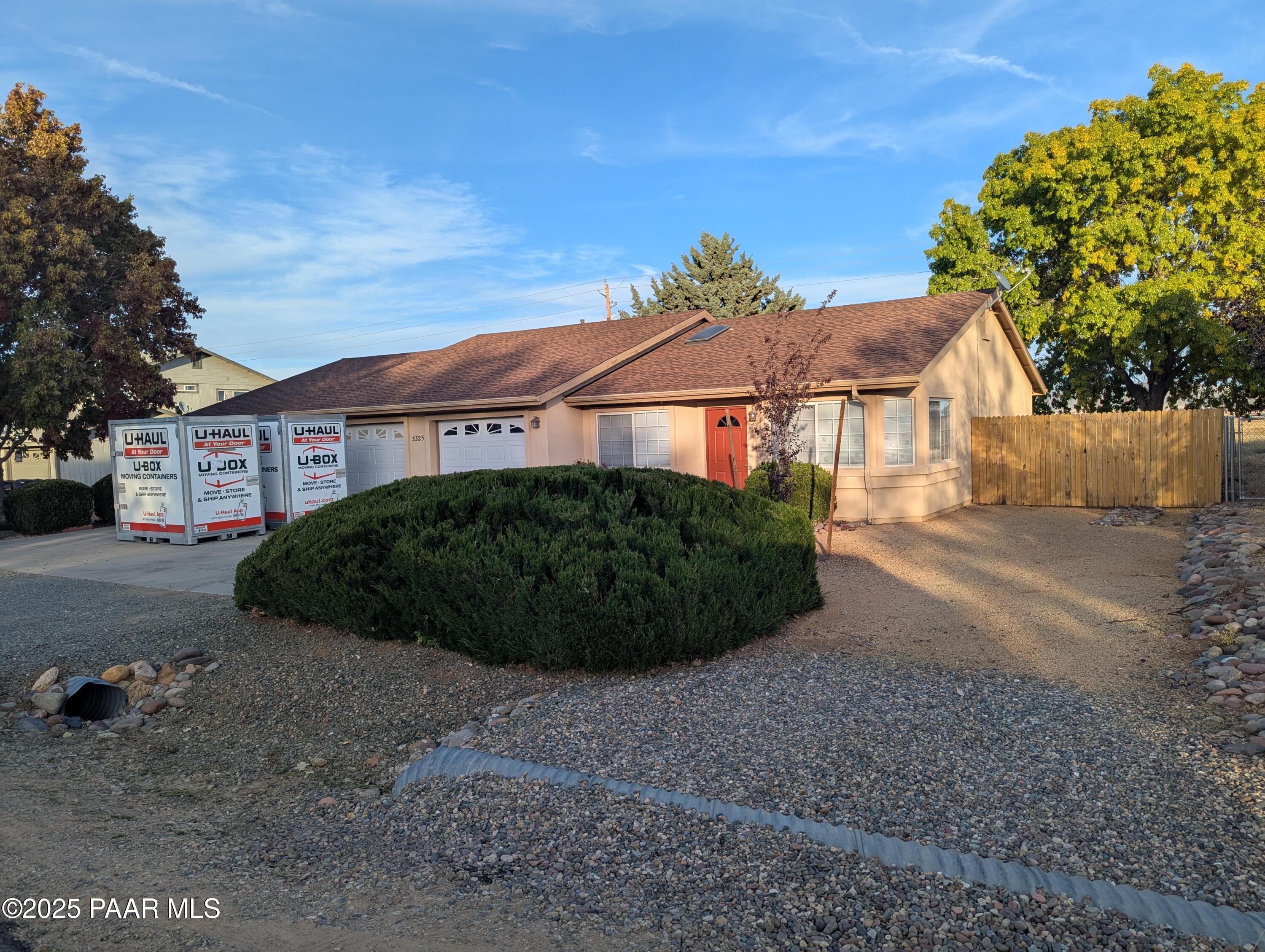 3325 East Yavapai Road, Unit B Prescott Valley, AZ 86314 - Photo 2 of 12 a view of a large house with a yard and large tree