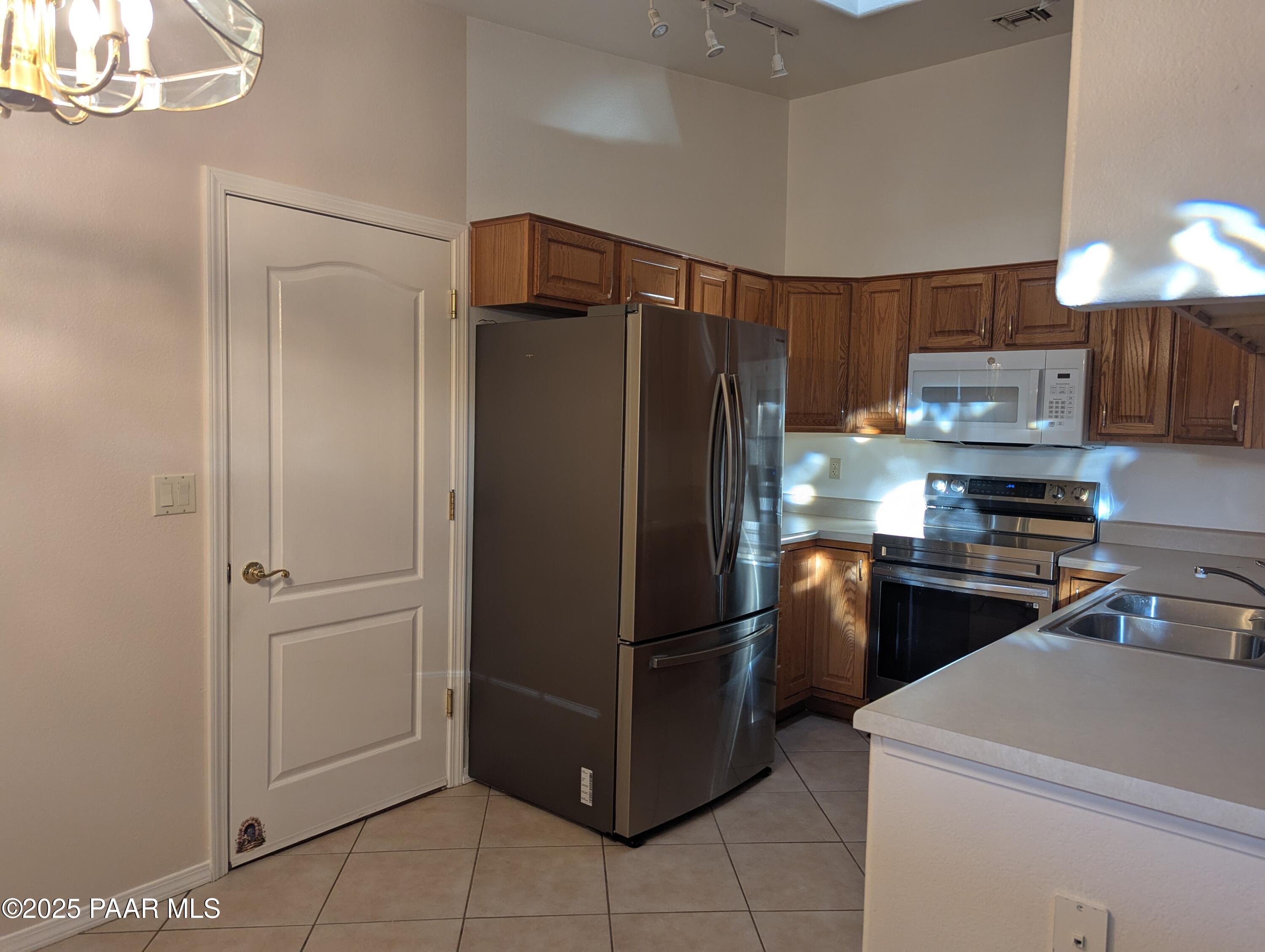 3325 East Yavapai Road, Unit B Prescott Valley, AZ 86314 - Photo 3 of 12 a kitchen with a refrigerator and a sink
