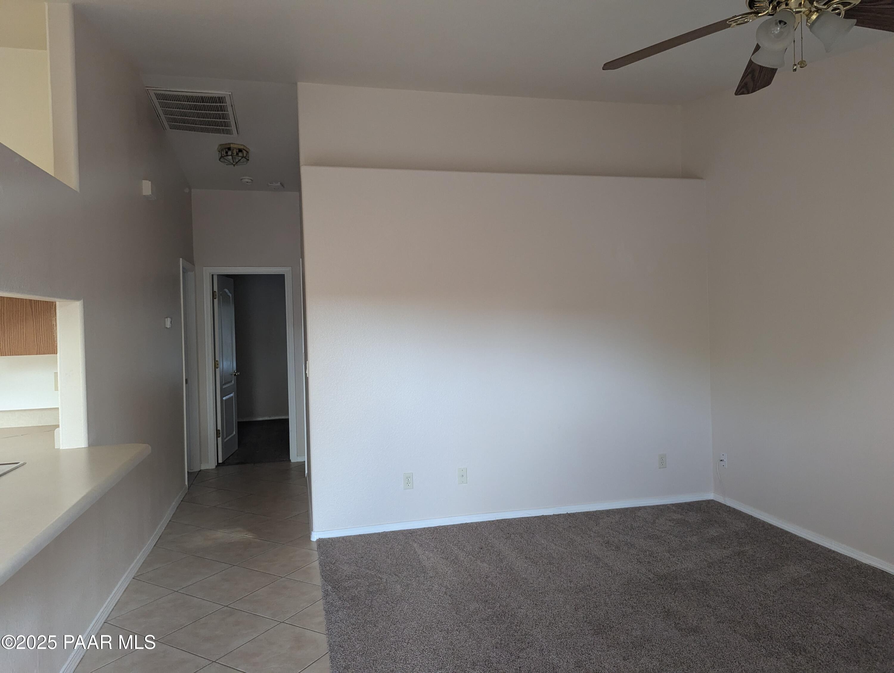 3325 East Yavapai Road, Unit B Prescott Valley, AZ 86314 - Photo 5 of 12 a view of an empty room with a window