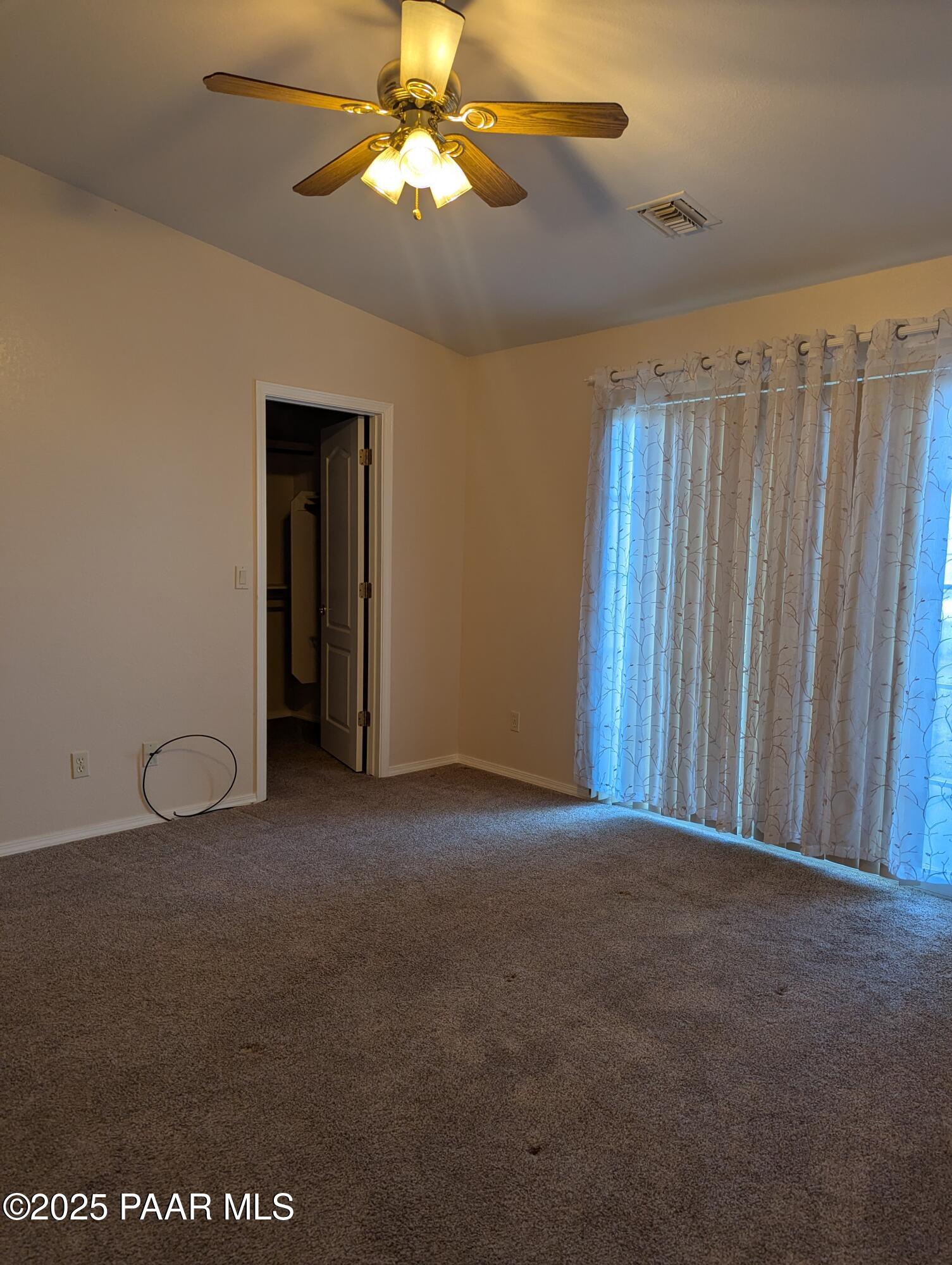 3325 East Yavapai Road, Unit B Prescott Valley, AZ 86314 - Photo 6 of 12 a view of a room with a chandelier fan and a ceiling fan