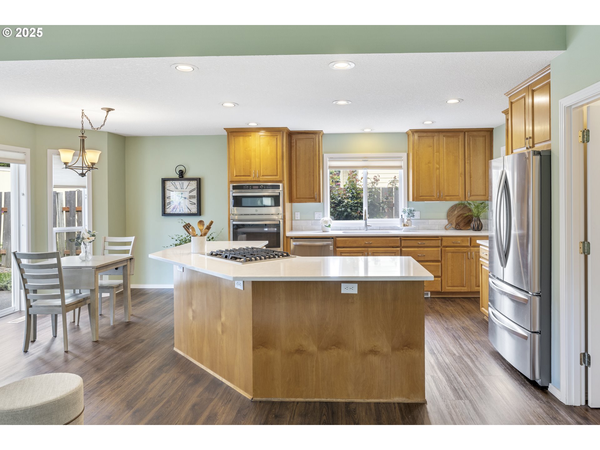 28519 Southwest Cascade Loop Wilsonville, OR 97070 - Photo 15 of 38 a kitchen with stainless steel appliances granite countertop a sink refrigerator and cabinets