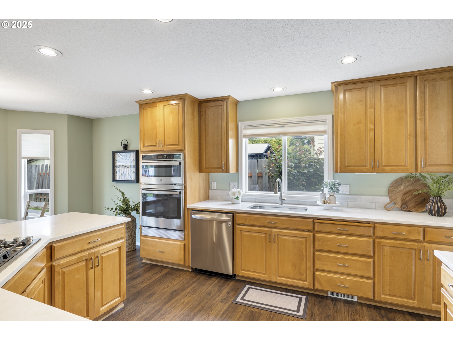 28519 Southwest Cascade Loop Wilsonville, OR 97070 - Photo 16 of 38 a kitchen with a sink stove and cabinets