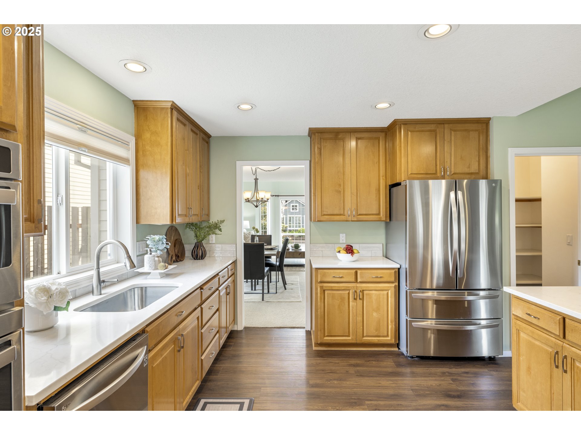 28519 Southwest Cascade Loop Wilsonville, OR 97070 - Photo 18 of 38 a kitchen with stainless steel appliances granite countertop a refrigerator a sink a stove and island