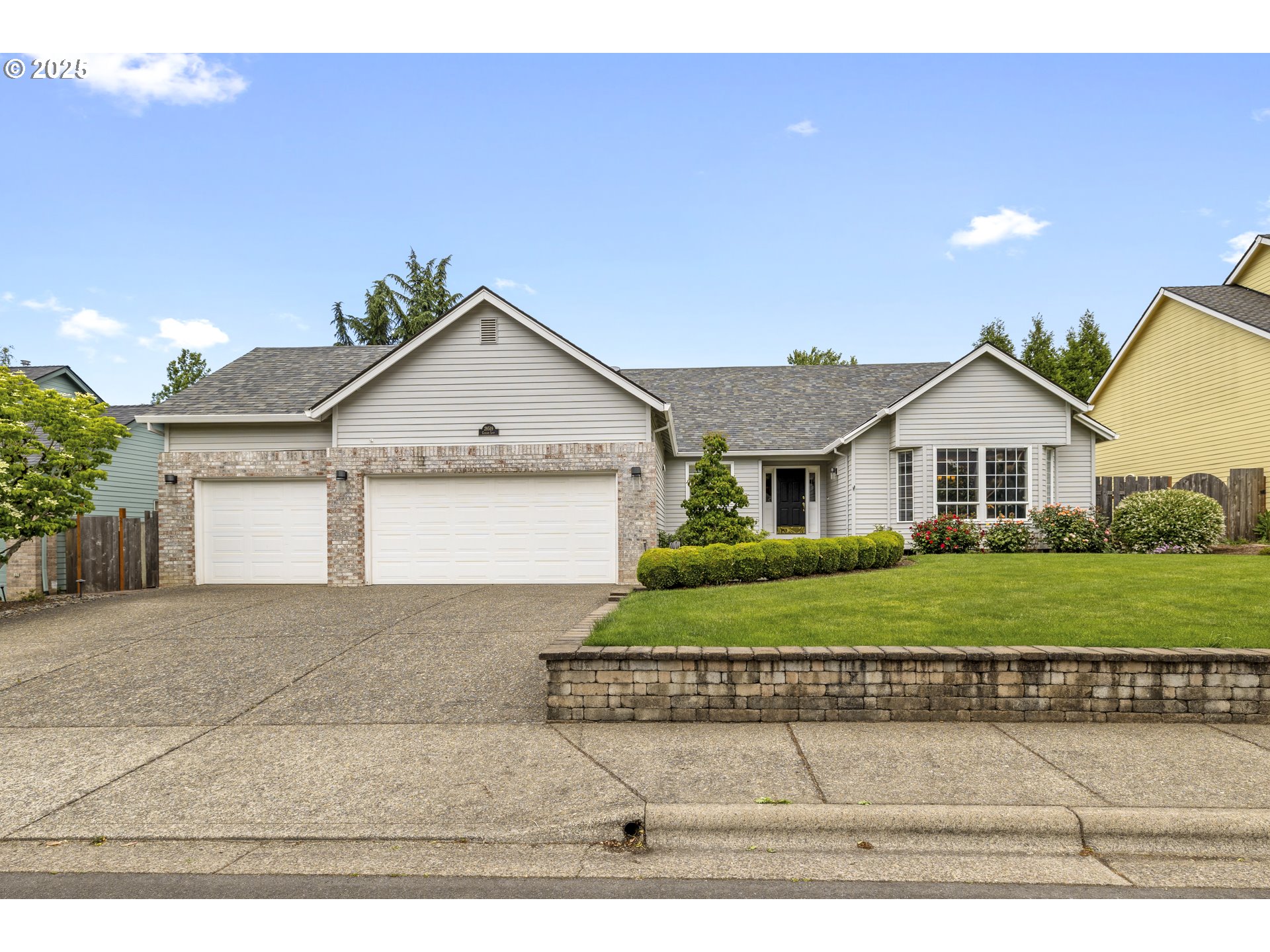 28519 Southwest Cascade Loop Wilsonville, OR 97070 - Photo 2 of 38 a front view of a house with a yard and garage