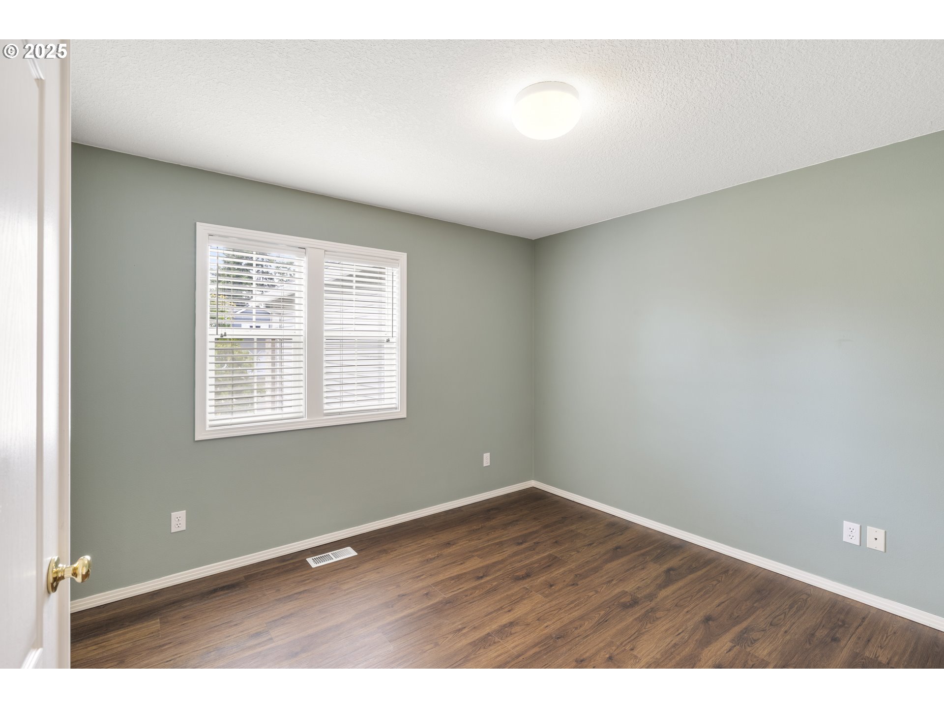 28519 Southwest Cascade Loop Wilsonville, OR 97070 - Photo 28 of 38 an empty room with wooden floor and windows