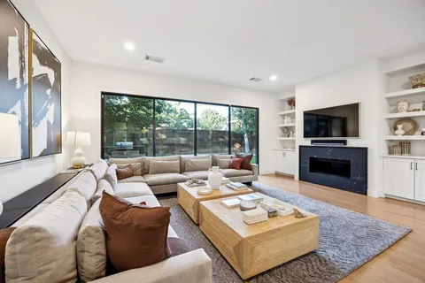 a living room with fireplace furniture and a flat screen tv