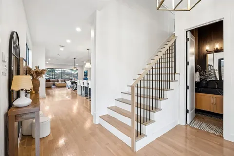 a view of entryway and hall with wooden floor