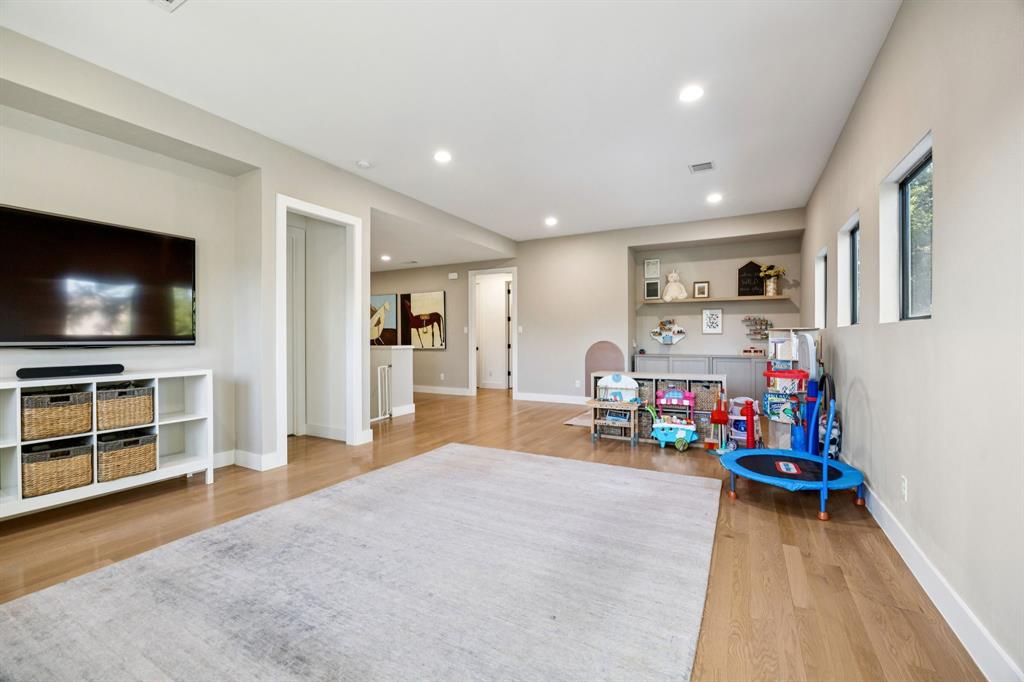 4419 Merrell Road Dallas, TX 75229 - Photo 22 of 27 a view of a livingroom with furniture and a flat screen tv