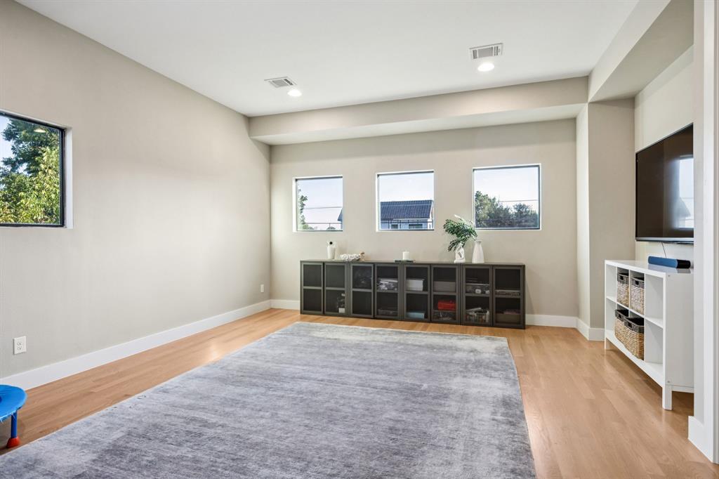 4419 Merrell Road Dallas, TX 75229 - Photo 23 of 27 a living room with furniture flat screen tv and windows