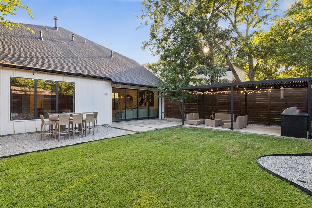 4419 Merrell Road Dallas, TX 75229 - Photo 26 of 27 a view of a chair and table in backyard of the house
