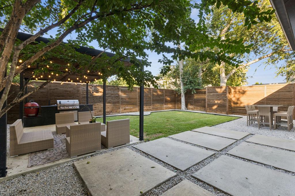 4419 Merrell Road Dallas, TX 75229 - Photo 27 of 27 a view of a backyard with couches plants and large trees