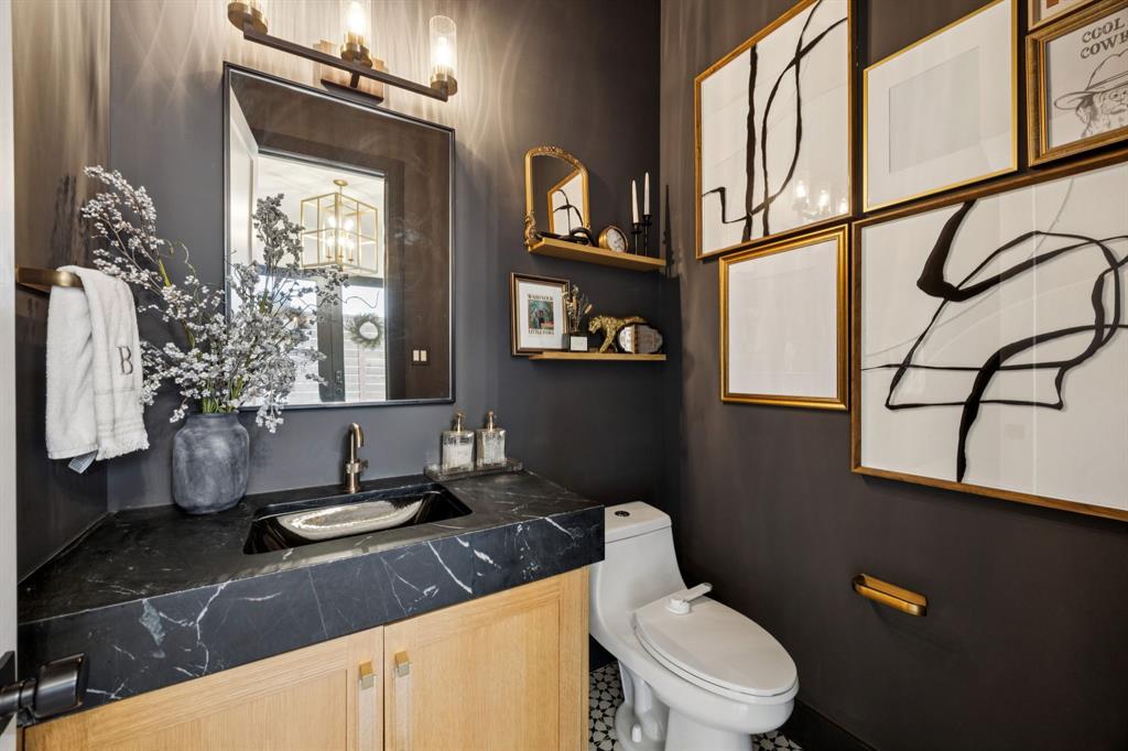 4419 Merrell Road Dallas, TX 75229 - Photo 4 of 27 a bathroom with a granite countertop sink mirror vanity and toilet