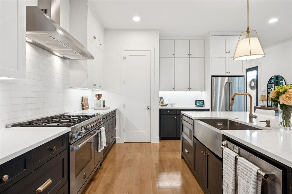 4419 Merrell Road Dallas, TX 75229 - Photo 8 of 27 a kitchen with stainless steel appliances granite countertop a sink stove and refrigerator