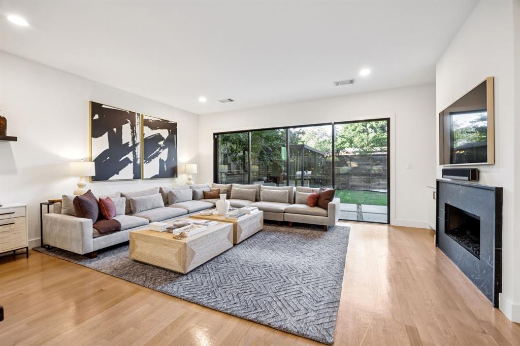 4419 Merrell Road Dallas, TX 75229 - Photo 10 of 27 a living room with furniture fireplace and flat screen tv